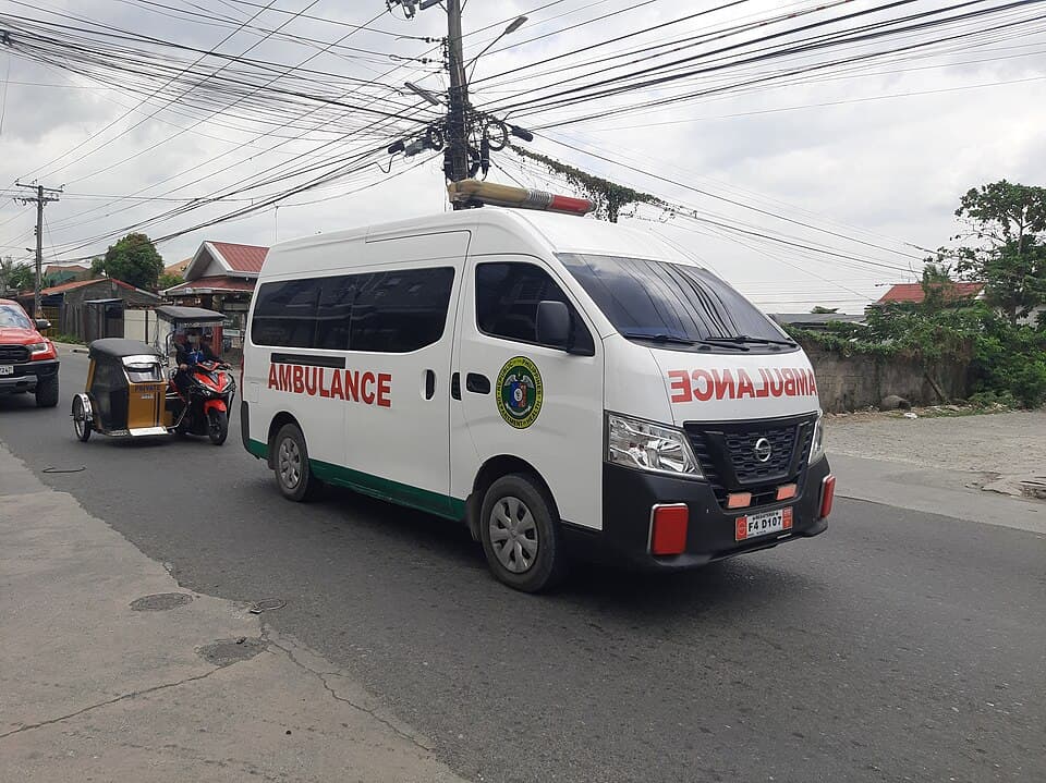 A white ambulance van on a Philippine street