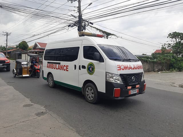 A white ambulance van on a Philippine street