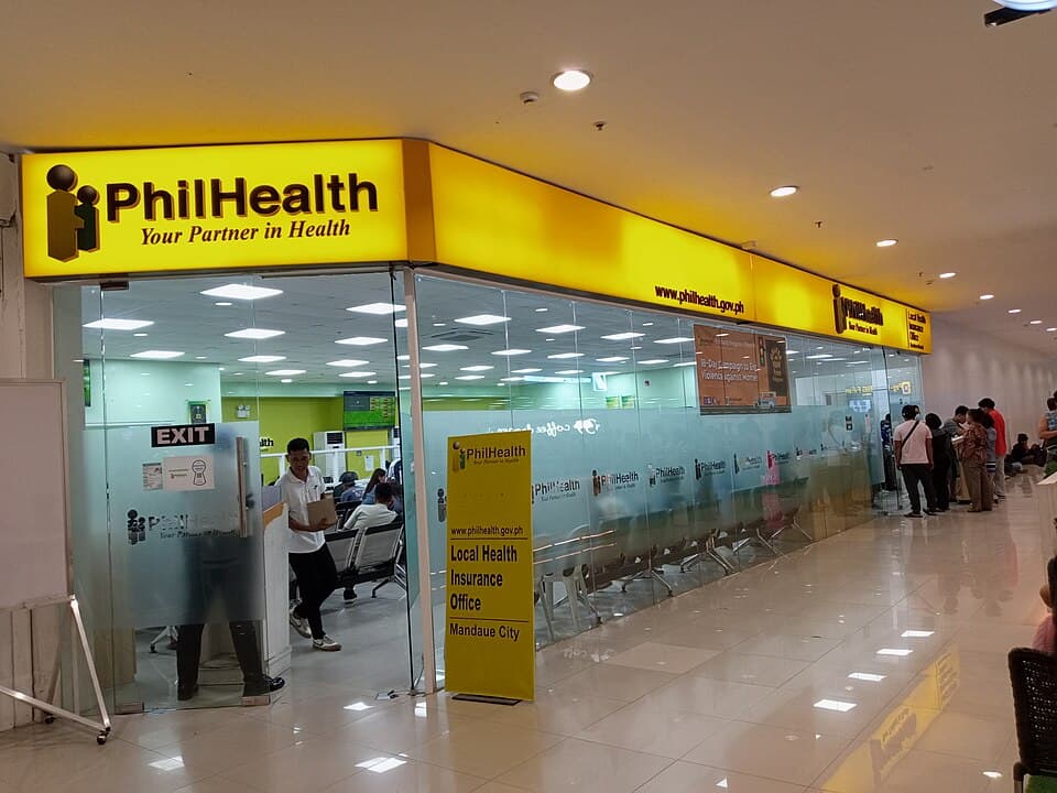 The PhilHealth Local Health Insurance Office inside Parkmall in Mandaue City, Cebu, with members waiting outside its glass front