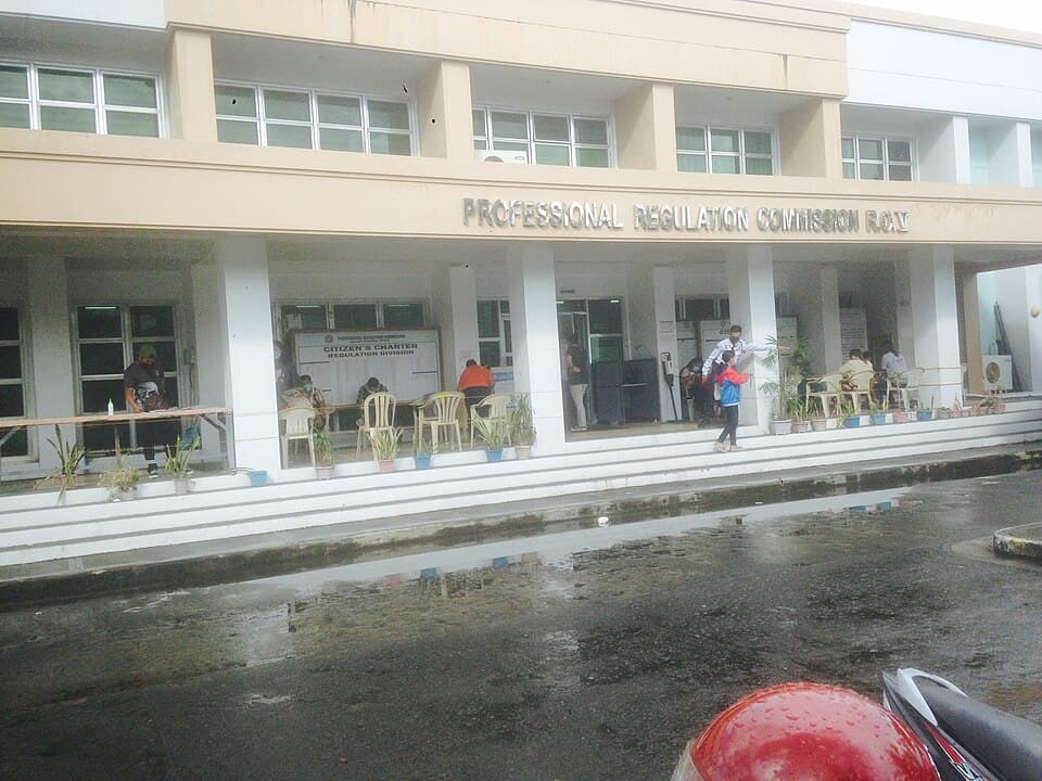 People at the entrance of the Professional Regulation Commission regional office building in Rawis, Albay