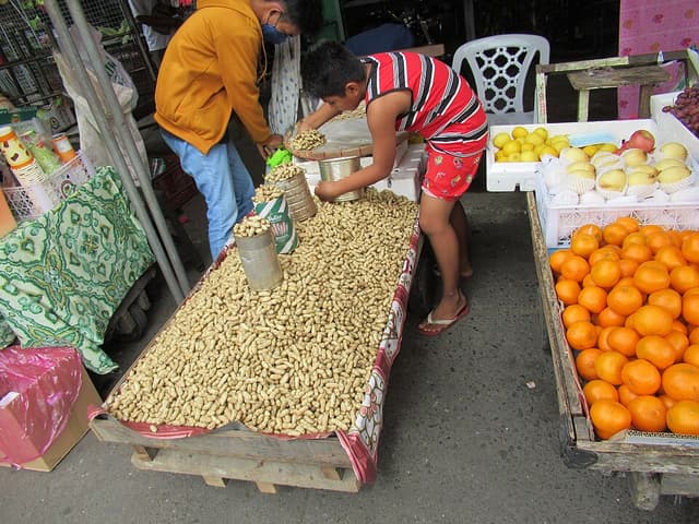A vendor and customer at a public market stall in the Philippines