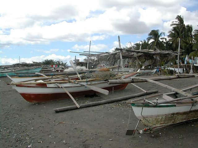Fishing pumpboats docked on a beach in the Philippines