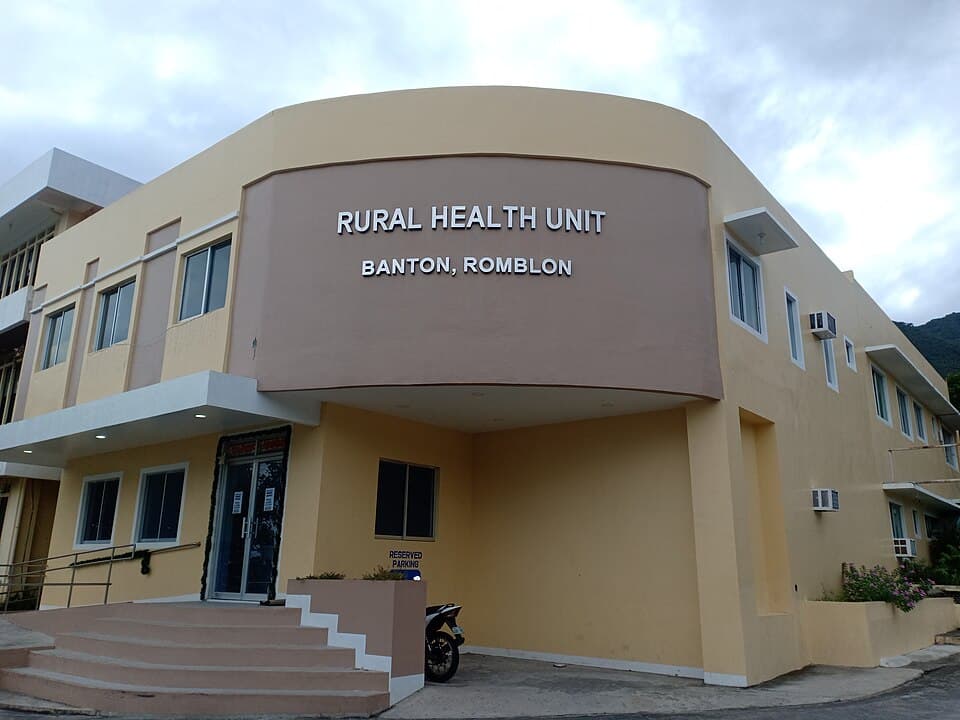The two-storey Rural Health Unit building of Banton, Romblon, with its name in raised letters above the entrance, shown as a representative example of a Philippine public primary care facility