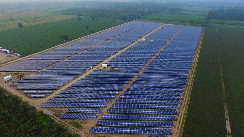 Aerial view of rows of solar panels at the Surallah Photovoltaic Power Plant in Barangay Centrala, Surallah, South Cotabato, surrounded by farmland, shown as a representative example of a Mindanao solar plant