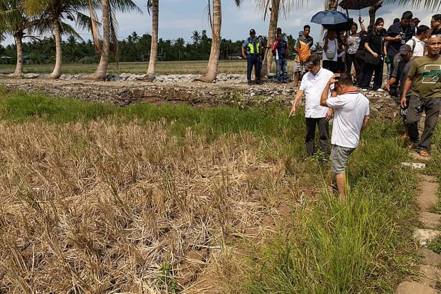 Senator Kiko Pangilinan and farmers look over a dried-up rice field in Barangay Comun, Camalig, Albay, during a May 2026 inspection of drought damage