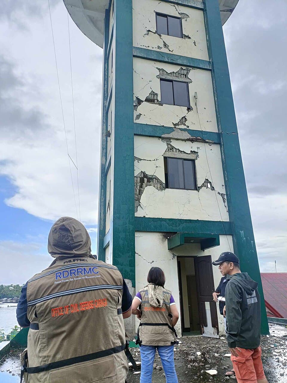 Office of Civil Defense Caraga personnel inspect the cracked walls of the PAGASA Doppler radar station in Hinatuan, Surigao del Sur, a day after the December 2, 2023 earthquake