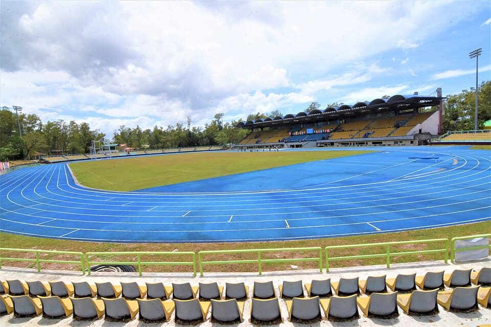 The renovated Panaad Stadium in Bacolod City, Negros Occidental, with a blue running track around a grass field and a covered grandstand on the far side