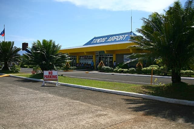 The yellow and blue terminal building of Tandag Airport in Tandag City, Surigao del Sur, another government-run airport in the province, photographed in 2016