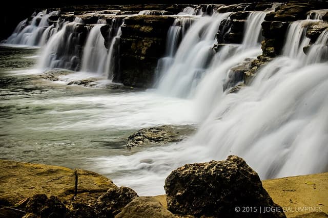 Water cascading over wide rock ledges at Tinuy-an Falls in Bislig City